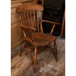 A 19th century beech and elm kitchen armchair with stick back and solid seat, on turned legs with '