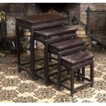 A nest of four graduated Chinese hardwood occasional tables, with pierced friezes, on square legs,