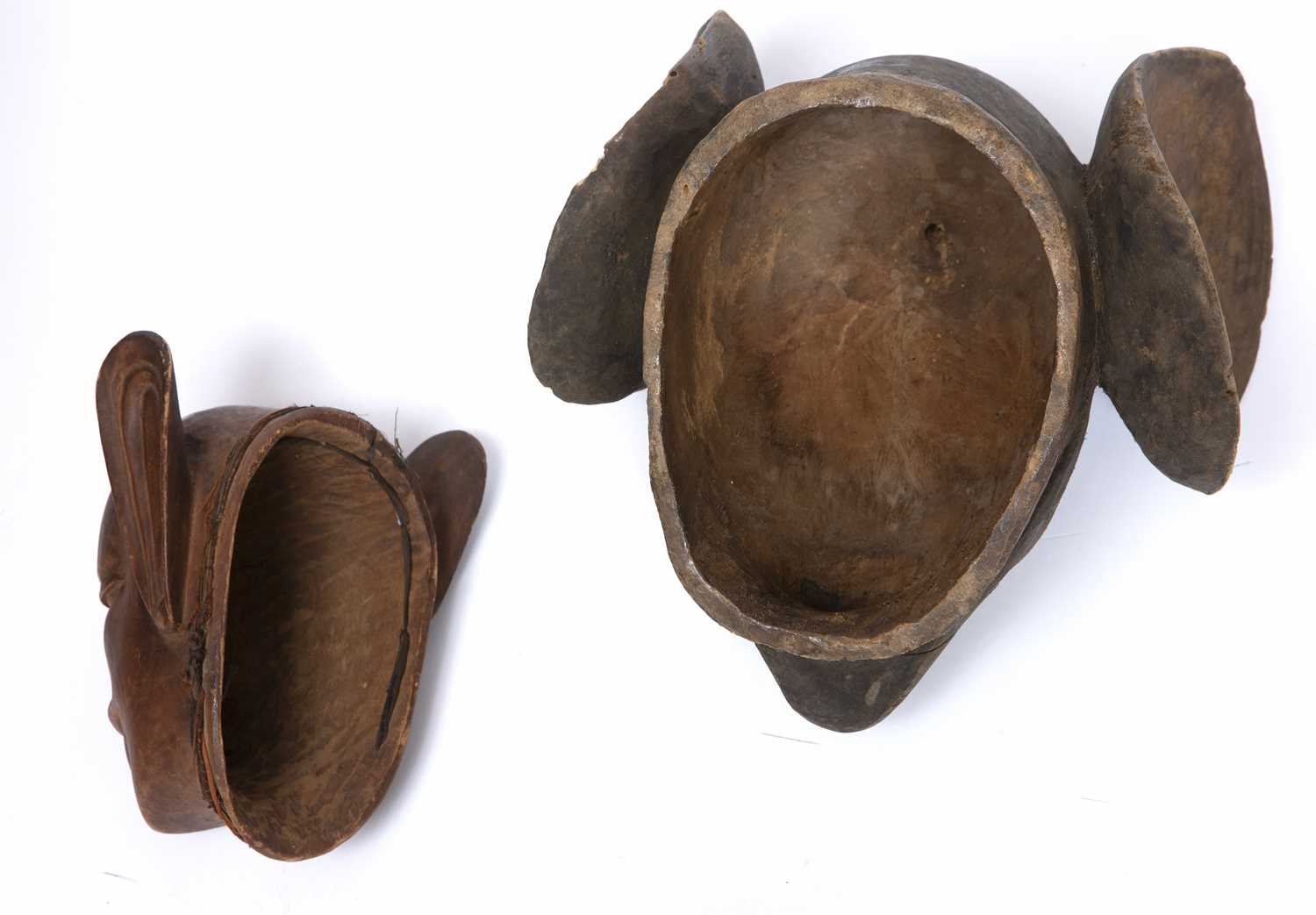 A Makonde helmet mask, Mozambique, carved wood with a grotesque face and large ears with another - Image 2 of 2