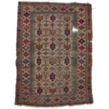 An Antique Caucasian rug with hooked medallions within a multi-coloured border, 143 x 106cm