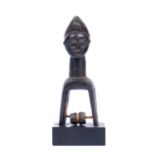 A West African head pulley with stand, carved wood figure torso with crescent coiffure, 21.5cm