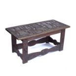 A Benin carved wooden rectangular table or seat on stretcher support and carved with a central OBA