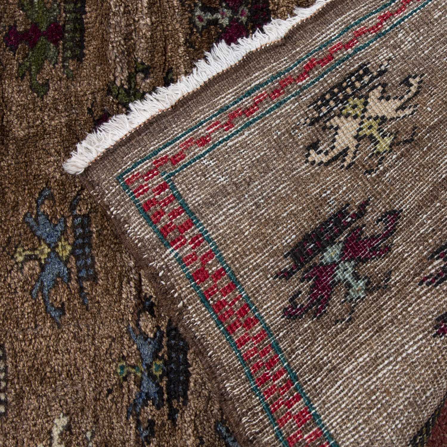 A Turkish rug with multi-coloured flower design on a brown ground, 115 x 81cm - Image 2 of 2