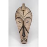 A Fang mask, Gabon, carved wood with incised line marks with black and white pigments, 74cm high