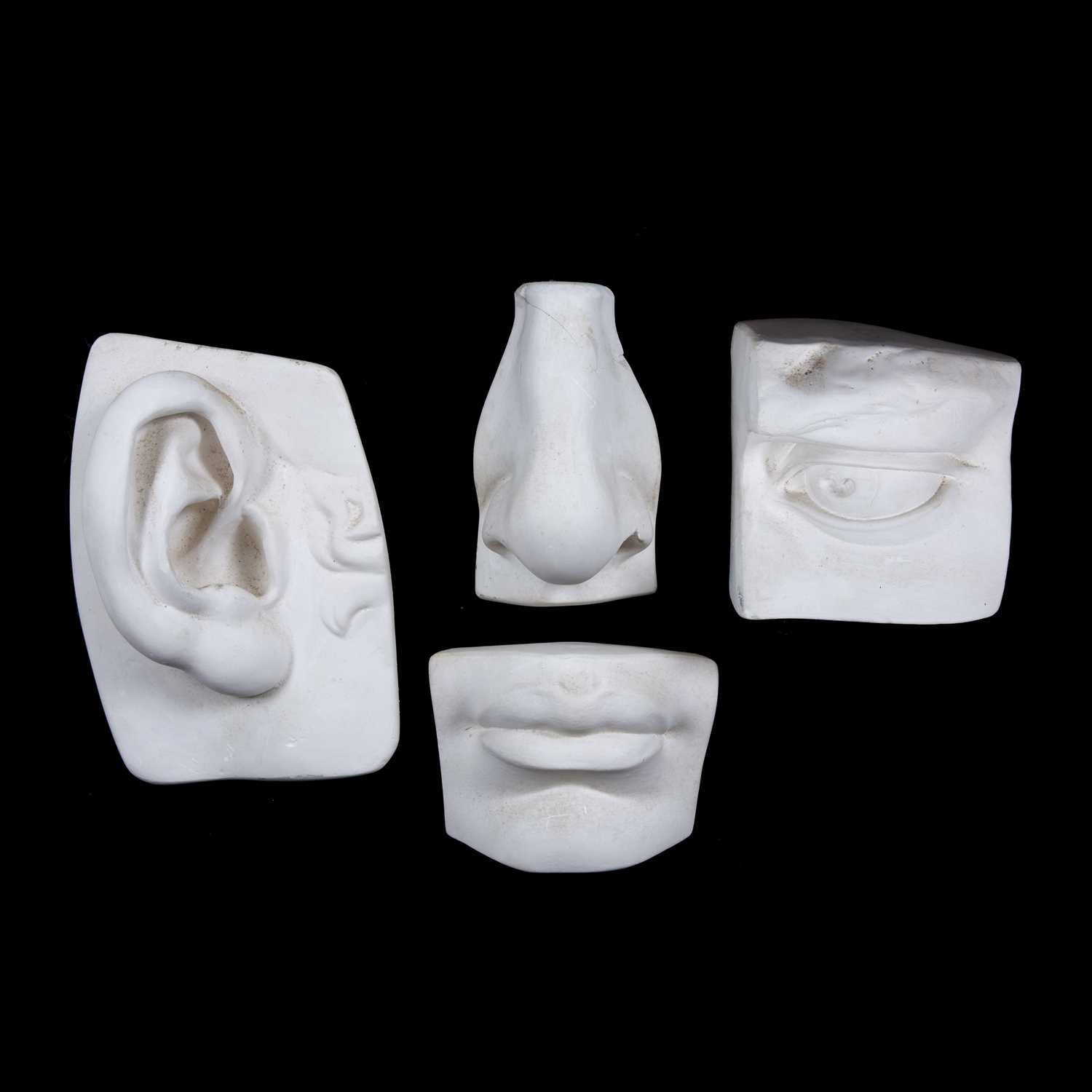 A group of four artist's plaster anatomy models, ear, mouth, nose and eye, 25 x 18cm and smaller (