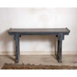 A Chinese painted hardwood altar table, on shaped end supports, 137cm wide