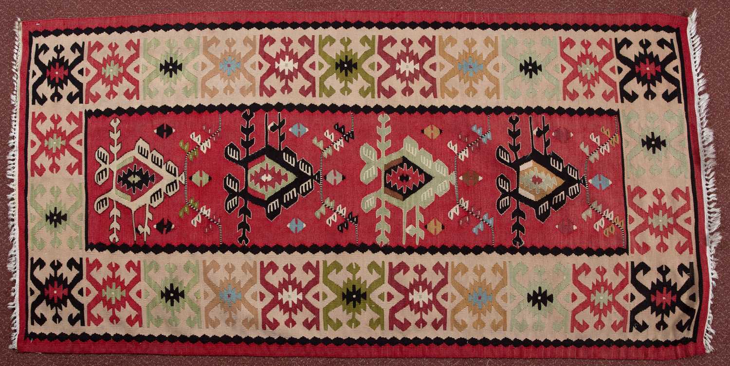 A Serbian Pirot Kelim with a colourful design of hooked medallions, 167 x 84cm