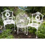 A Victorian white painted wirework garden chair; and a pair of white painted aluminium garden chairs