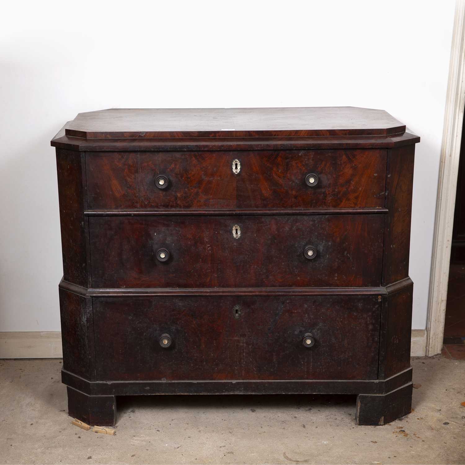 An early 19th century French mahogany chest of three long drawers, of canted rectangular outline,