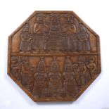 A Benin carved wooden hexagonal table top with OBA figures and multiple attendants, 61cm