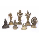 A group of seven Indian and Chinese brass deity figures including Buddha, Shiva, 21.8cm high (7)
