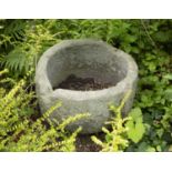 An antique stone font, of shaped circular form, 57cm wide