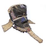 A large Kuba bwoom helmet mask, carved wood decorated with metal panels, multicoloured trade beads