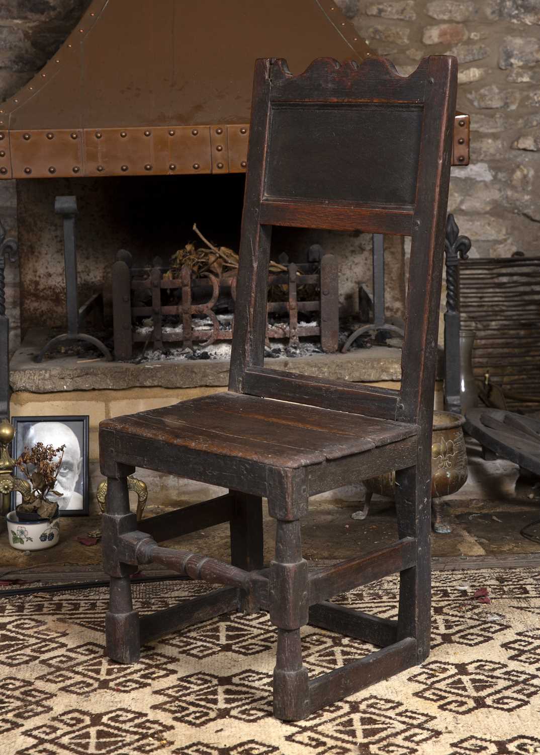 An 18th century oak side chair, the panelled back with shaped top rail, having solid seat, on turned - Image 2 of 3