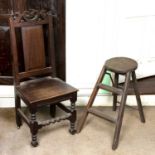 An 18th century oak side chair, the panelled back with scroll pierced top rail, having solid seat,