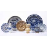 An 18th century Dutch Delft blue and white pottery deep bowl decorated a garden scene, 31cm; another