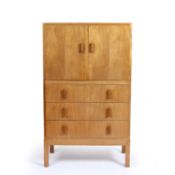 Gordon Russell (1892-1980) walnut tallboy, two doors over three drawers, copper plaque to the