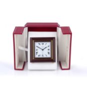Les Must de Cartier alarm clock in fitted case, the white dial with Roman numerals, marked Cartier