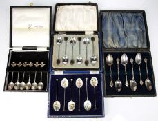 Four cased sets of silver spoons consisting of a set of six commemorative silver teaspoons with