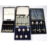 Four cased sets of silver spoons consisting of a set of six commemorative silver teaspoons with