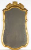 A George III style gilded overmantle mirror with shaped edge and bevelled glass, 48cm wide x 92cm