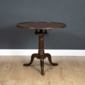 A George III and later mahogany tripod table with a single plank tray top and a bird cage support,
