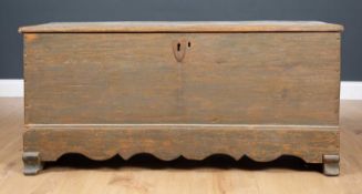 An antique pine chest with wrought iron hinges, heart shaped escutcheon and shaped apron, fitted