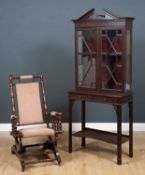 An Edwardian chinoiserie style mahogany display cabinet with breakarch cornice and blind fretwork