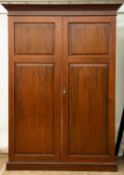 An early to mid 20th century mahogany compactum style two door wardrobe by 'Innovation' with hanging