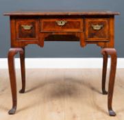 An 18th century walnut lowboy with three drawers, cabriole legs and square feet,79cm wide x 51cm