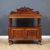 A Victorian Mahogany buffet with a carved and raised back, a single frieze drawer, turned supports