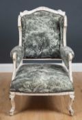 A painted wing back small armchair in the French style with 'distressed' paintwork and newly