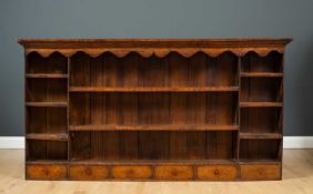 A 19th century oak dresser plate rack with various shelves and six small drawers, 193.5cm wide x