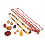 A collection of jewellery, comprising an amber and heat-treated amber single strand bead necklace, a
