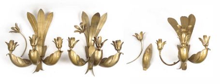 A set of three painted metal three branch wall lights of foliate form, each 43cm wide x 28cm deep