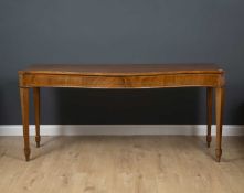 A 19th century mahogany serpentine fronted serving table with square tapering legs, 191cm wide x
