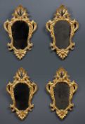 A set of four 19th Century Tuscan gilt framed wall mirrors, with decorative scrolling ornament, each