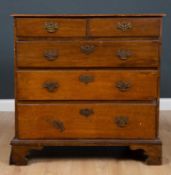 A George III oak chest of two short and three long drawers standing on bracket feet, 93cm wide x