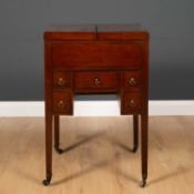 A George III mahogany wash stand with fold over top revealing recesses within, five various