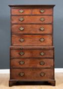 A George III mahogany chest on chest or tall boy with brushing slide and standing on bracket feet,