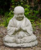 A cast reconstituted stone ornament in the form of a Budda figure sitting cross-legged, 49cm wide