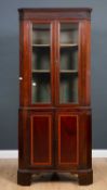 A George III mahogany satinwood inlaid floor standing corner cabinet with twin glazed doors above