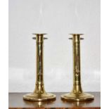 Pair of brass ejector candle sticks English, circa 1740-60, with domed bases 16cm high (2)