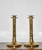 Pair of brass ejector candle sticks English, circa 1740-60, with domed bases 16cm high (2)