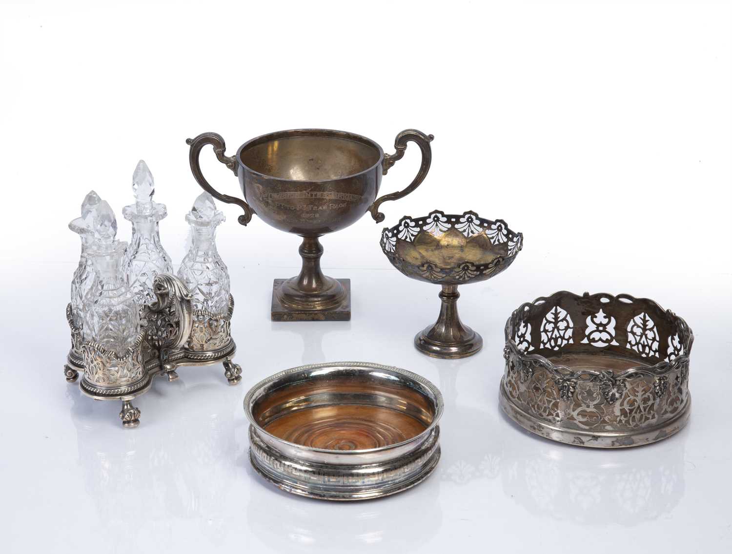 Collection of silver and silver-plated items to include: Three-piece glass cruet set on silver