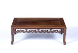 Hardwood low tableChinesecarved all around with cloud motifs to the rails, 27.5cm high, 75cm wide,