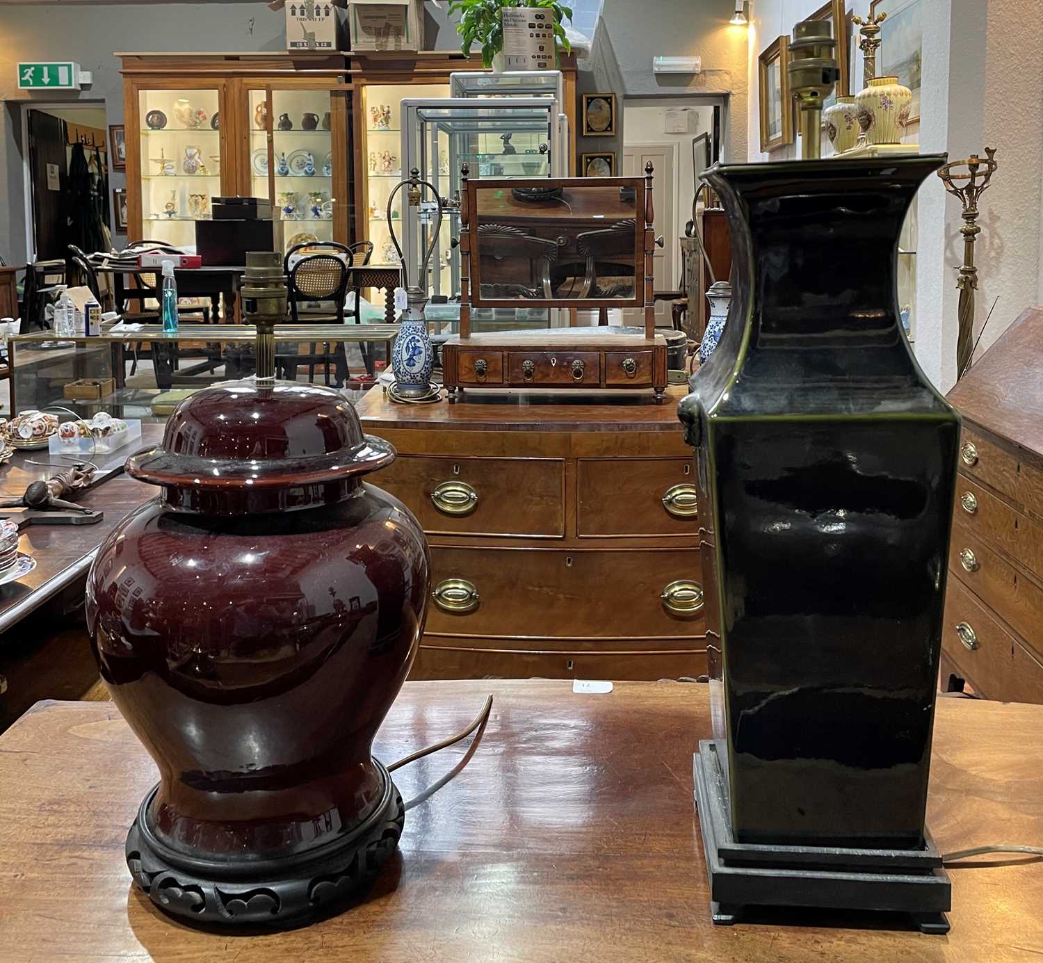 Two Chinese style table lamps each with a shade, 49.5cm high and 35cm high (excluding fittings)