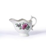Small porcelain cream jug 18th Century, probably Worcester, painted with a spray of flowers to