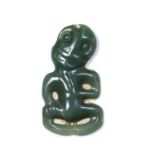 Maori hei-tiki pendant New Zealand, made of green nephrite, depicted with the head tilted to the