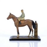 Cold painted metal cigar lighter in the form of a horse with jockey up, 17cm long x 17cm
